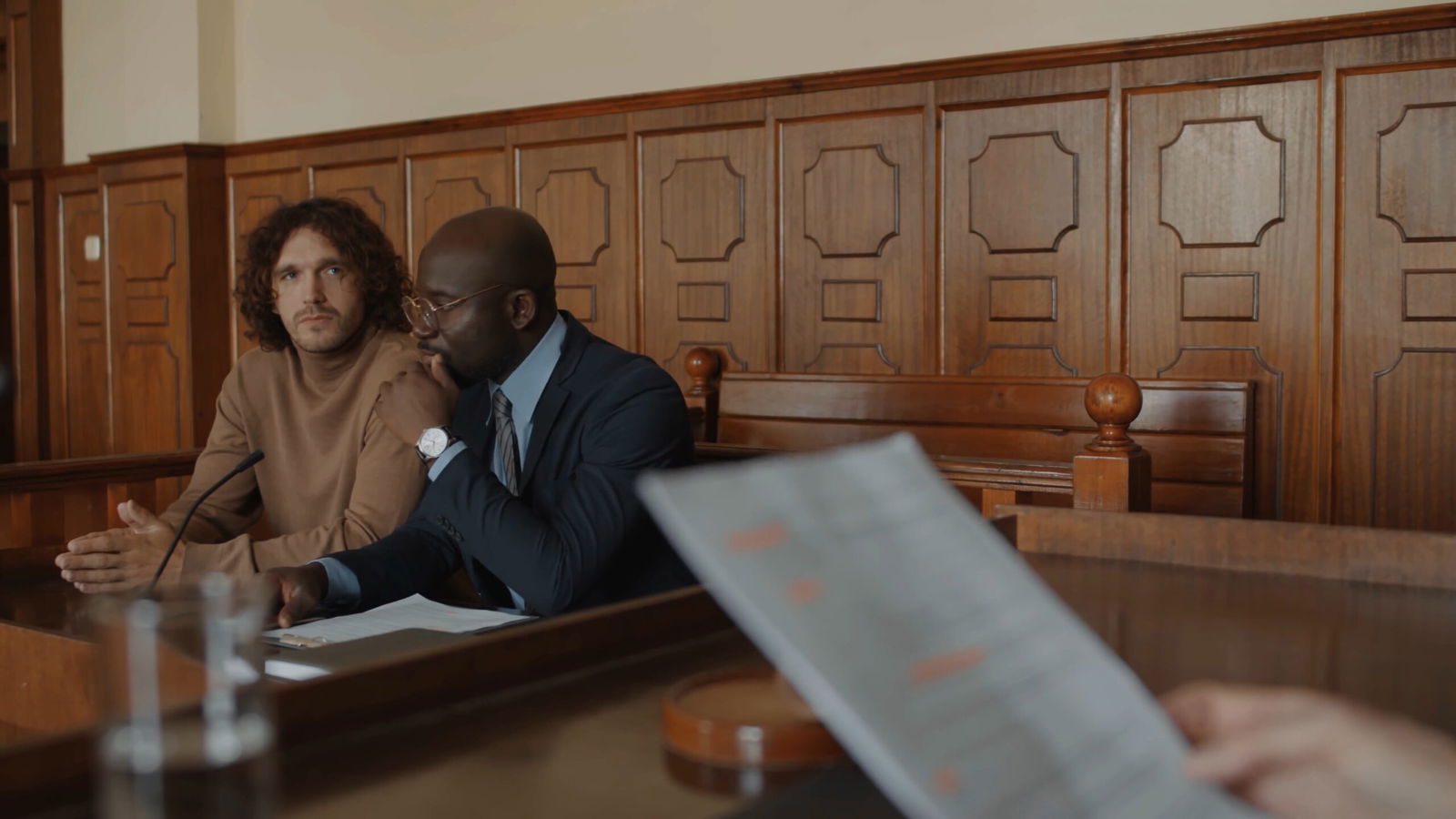 Protect Your Career: The Impact of Criminal Convictions on Professional Licensing in Ontario 3 02 caucasian young suspect and african american defence lawyer discussing points of co SBV 349200322 4K 00.00.05.331 scaled
