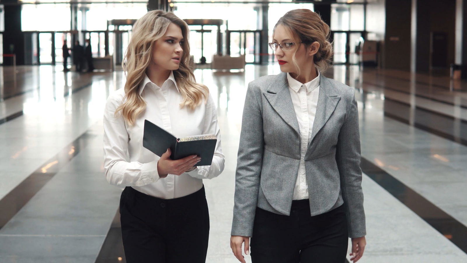 Protect Your Career: The Impact of Criminal Convictions on Professional Licensing in Ontario 6 05 head and assistant in an office building two business women walking along the corri SBV 326000508 4K 00.00.05.779 scaled