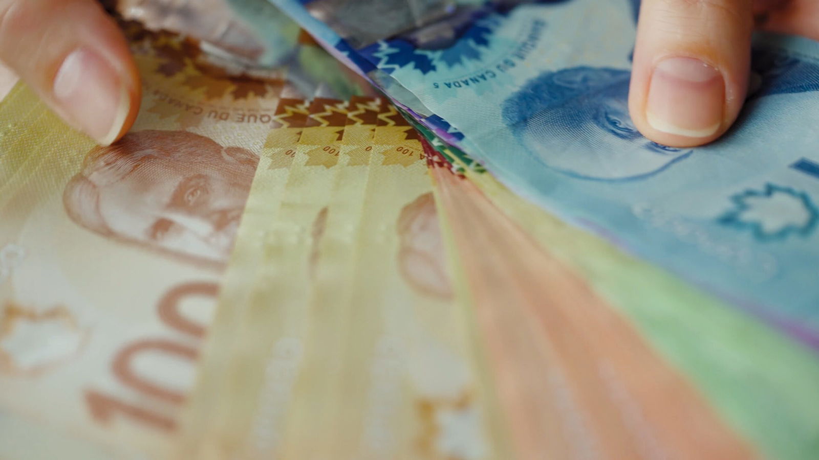 Know Your Vacation Rights in Ontario: Top 5 Facts 4 03 female hands counting canadian dollar bills close up SBV 347442071 4K 00.00.06.383 scaled