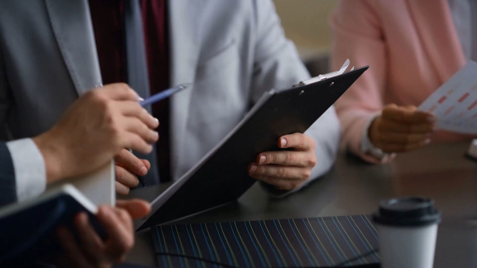Accused of Benefits Fraud? 6 Things You Need To Know 2 Lawyer reviewing forms with a client